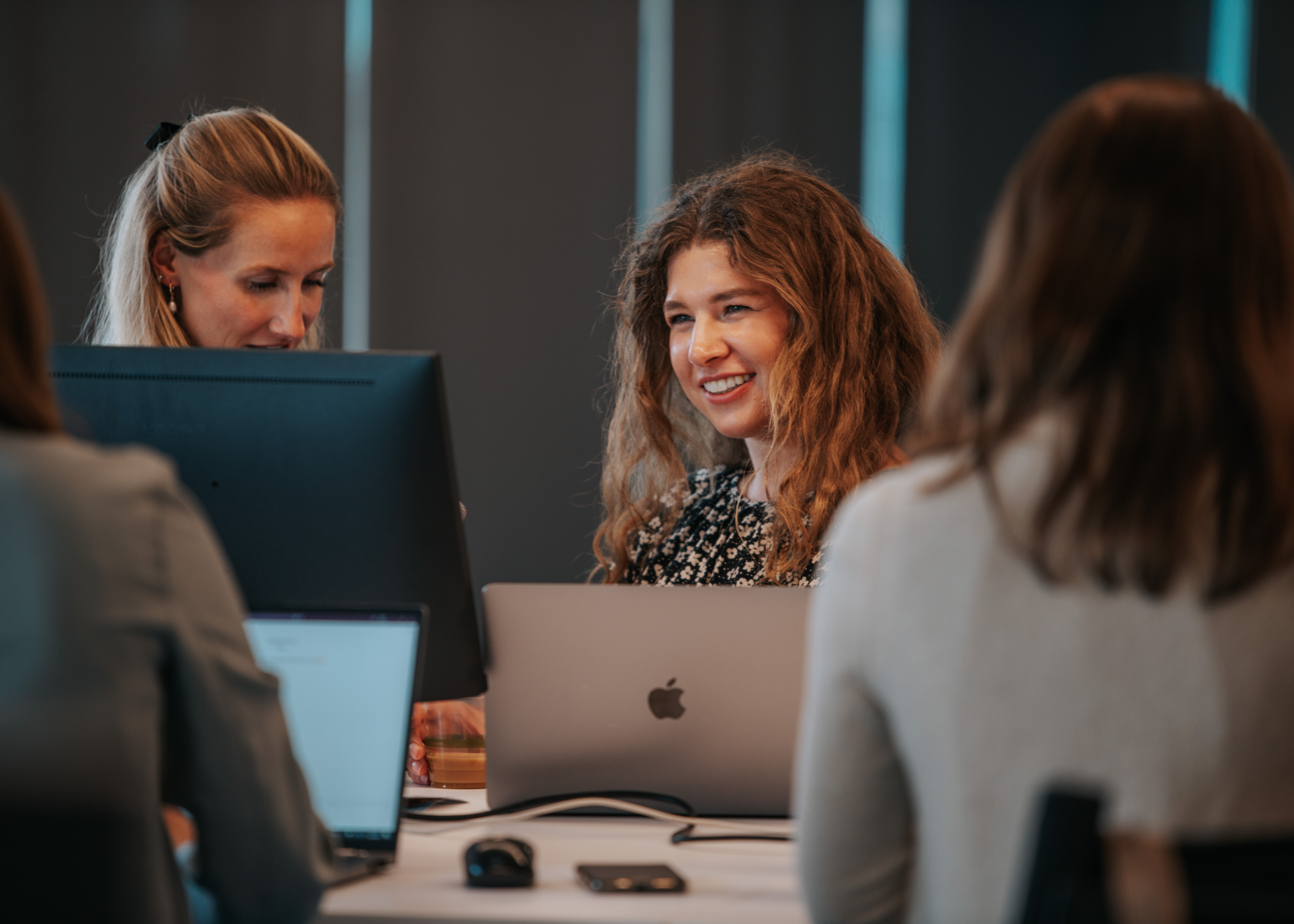 Velocity Global employees working side-by-side at the new headquarters in Denver, Colorado.