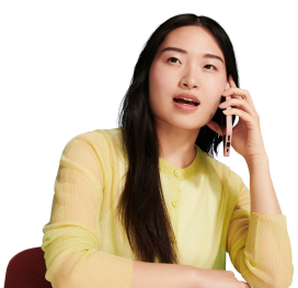 Woman in yellow sweater speaking on a cell phone