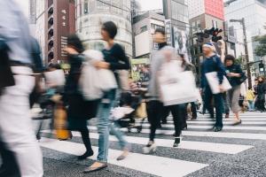 People crossing road in a busy intersection in Japan