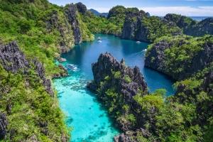 Kayangan Lake in Coron, Palawan, Philippines, surrounded by green islets and mountains
