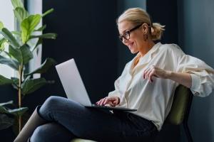 Woman smiling at laptop