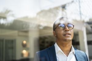 Male professional looking out a window