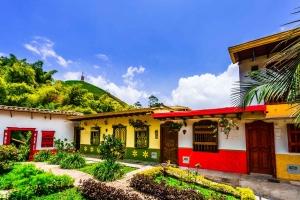 Photo of beautifully colored buildings in the green hills of Colombia