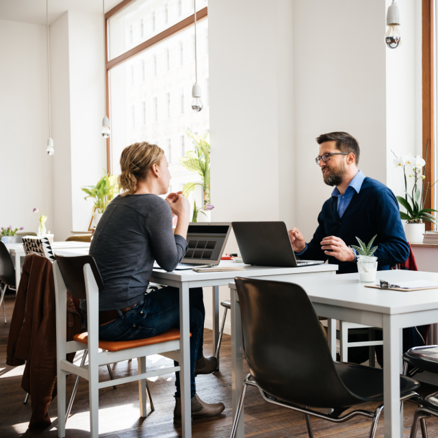 coworkers talking over a desk