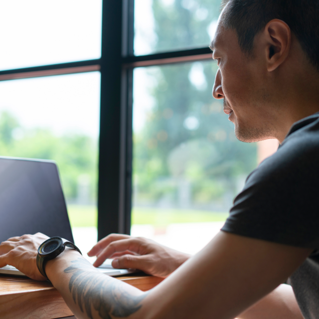 man typing on laptop