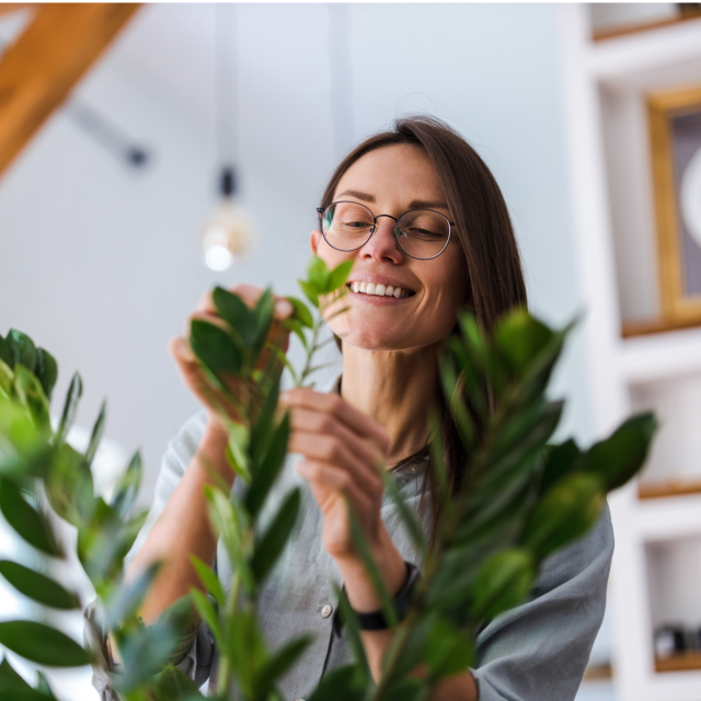 woman with glasses with indoor plant