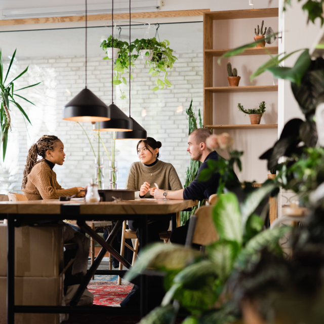 People sitting around a large table having a conversation