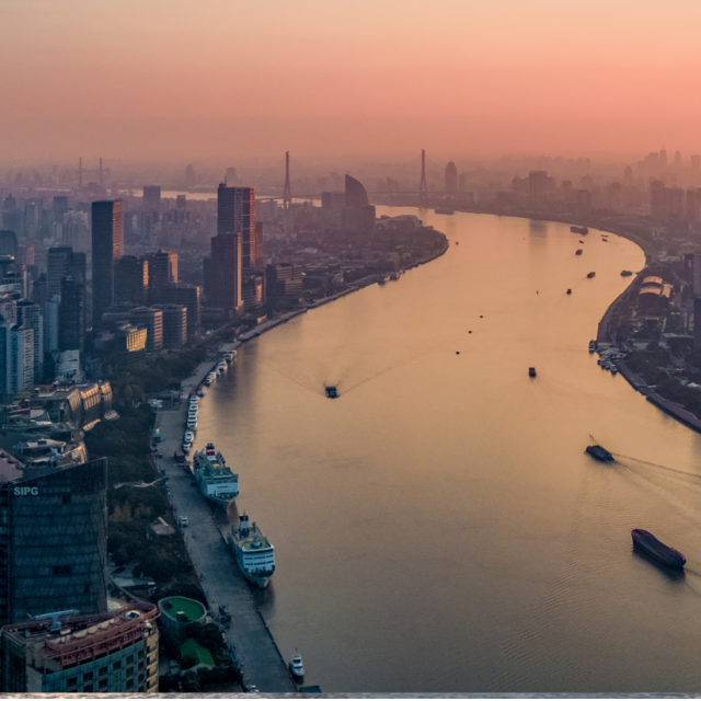city on either side of river with boats