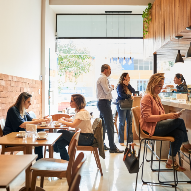People sitting and standing in a cafe