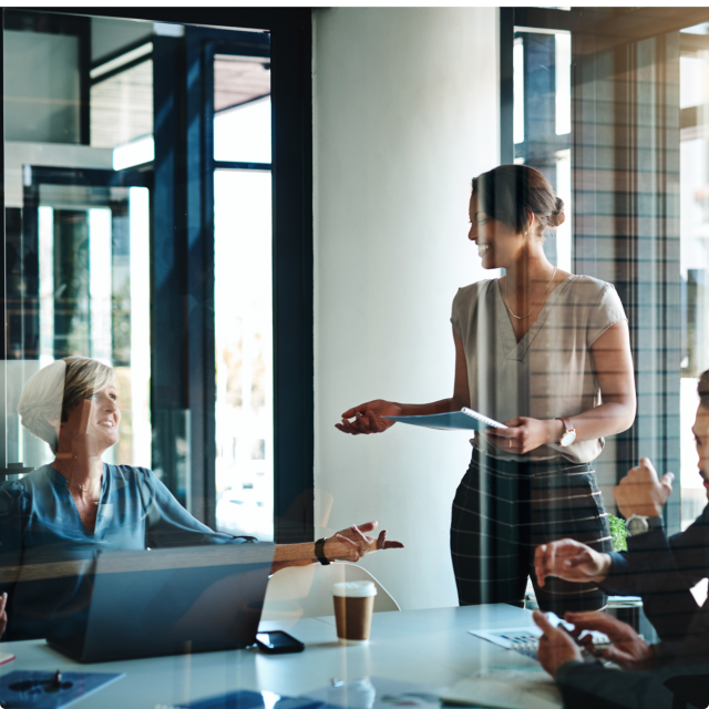 woman speaking to group of peers