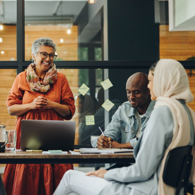 Professionals talking around a table in an office