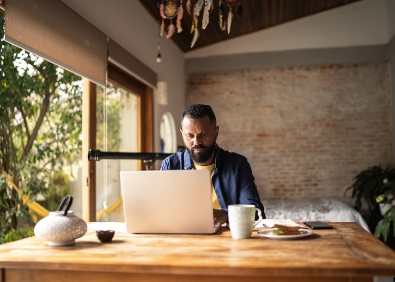 Remote worker reviewing their indefinite employment contract on laptop