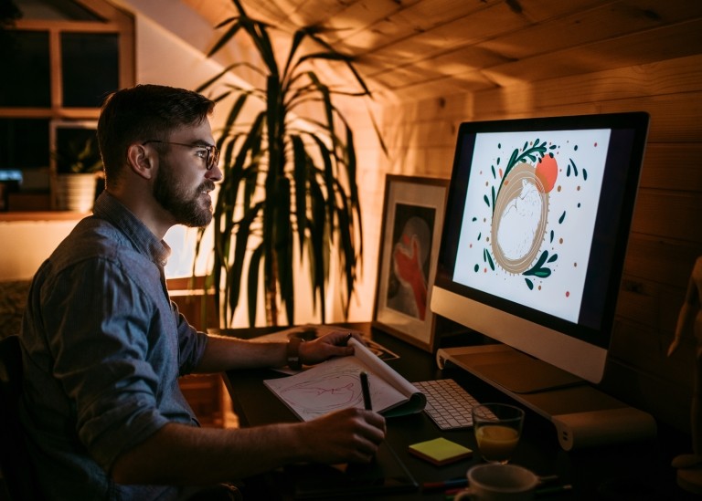 Man working on his computer at his home office