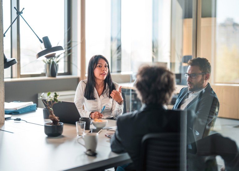 Professionals talking around a table in an office