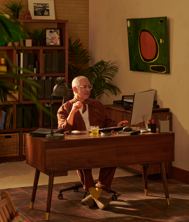 Older man sitting at desk in home office