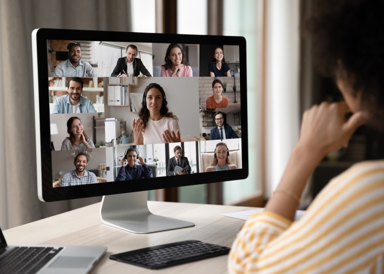 Woman working remotely on her desktop on a video meeting. 