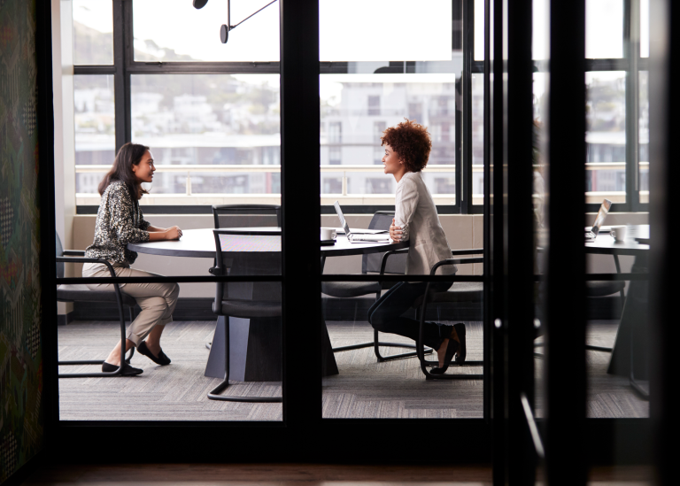 An HR manager conducting an interview with a potential new hire in a conference room