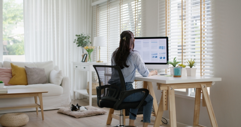 HR manager researches maternity leave by country in her home office