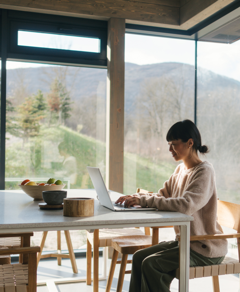 Global HR professional researching contractor management software on her laptop