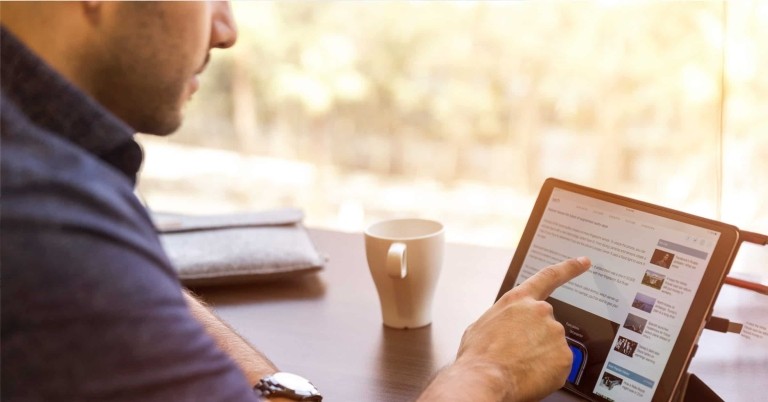 man pointing at tablet