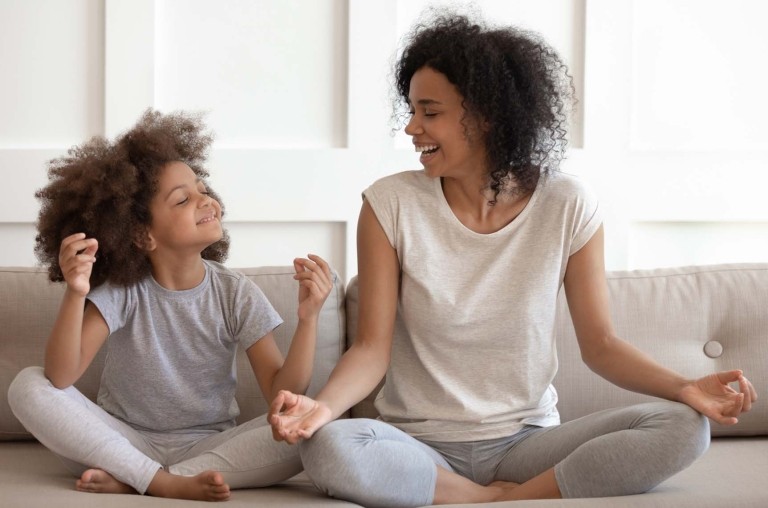 A woman and child on a child smiling and looking at each other