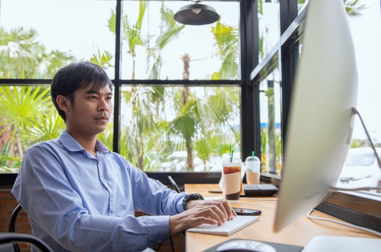 Asian businessman working at a coffee shop.