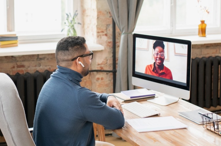 A manger meets with their global employee via video call