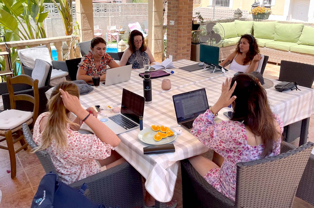 Velocity Global colleagues working poolside at the Co-Work World Retreat