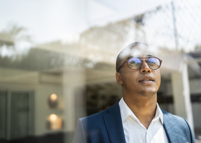 Male professional looking out a window