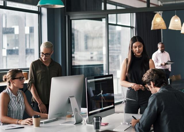 A hiring team discussing their global talent acquisition strategy