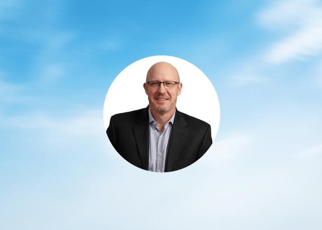 Blue sky in background with photo of Jeff Wollard, Velocity Global's Chief Financial Officer