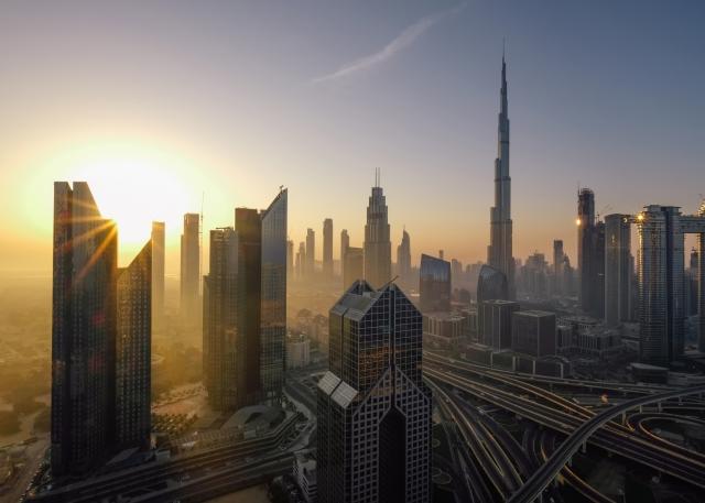 The Burj Khalifa skyscraper and surrounding skyline at sunset in Dubai, United Arab Erimates
