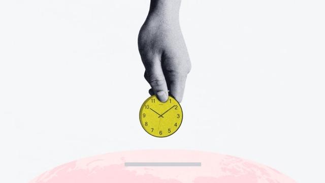 clock ticking over globe representing GDP