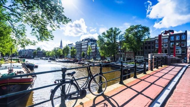 bike along canal in amsterdam