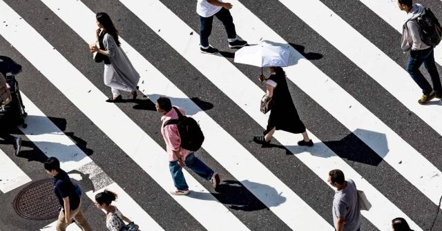 people walking on a checkered crosswalk